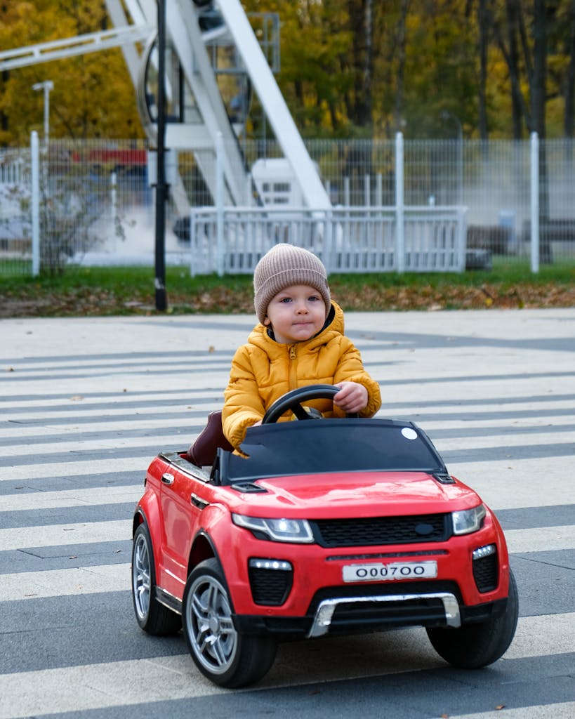 A Little Boy Driving a Toy Car