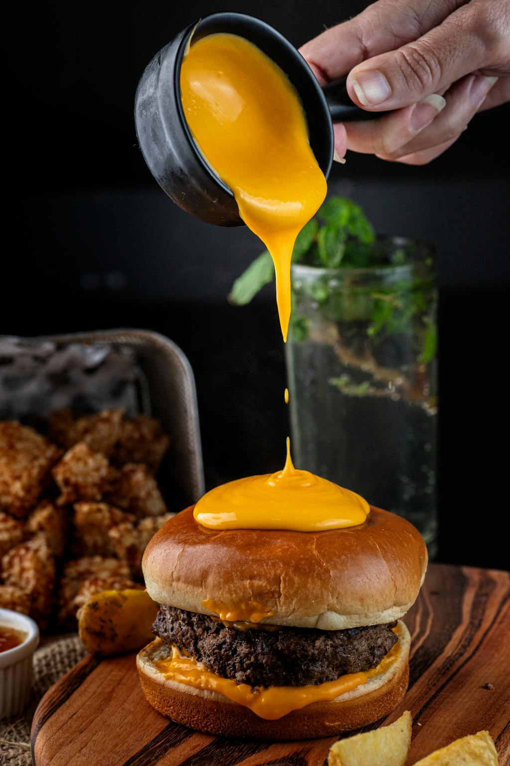 Pouring Sauce onto Tasty Hamburger
