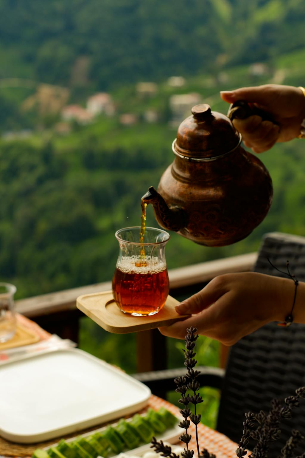 Woman Hands Pouring Tea to Glass