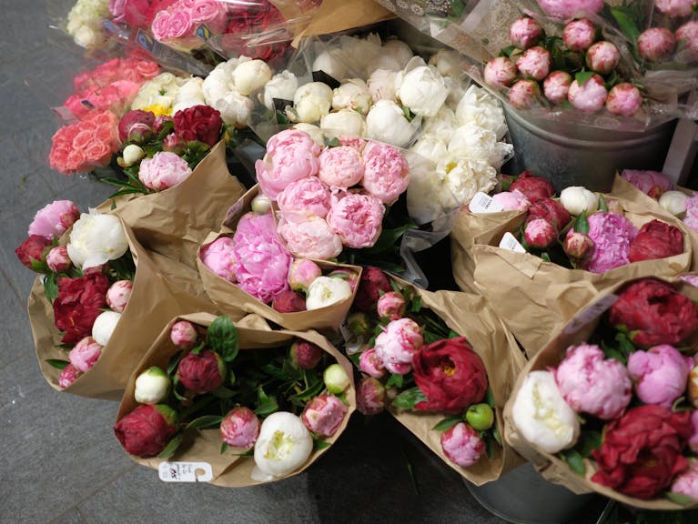 A bunch of flowers in brown paper bags
