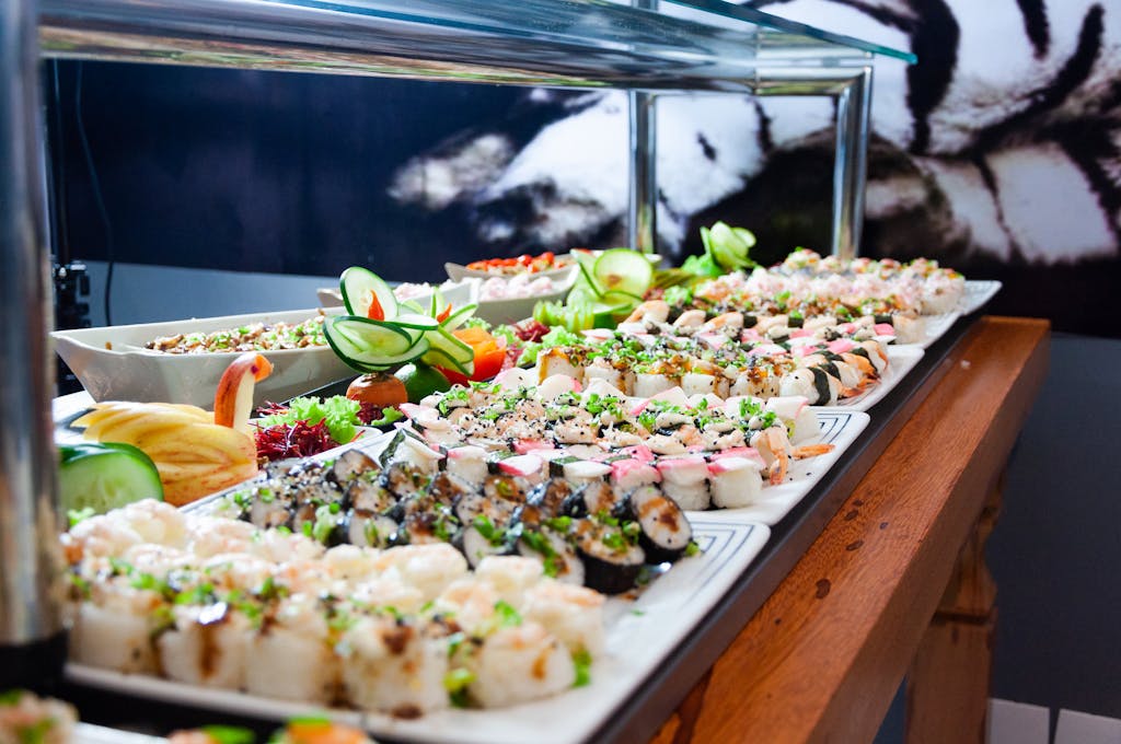 Sushi on White Plates on Brown Wooden Table